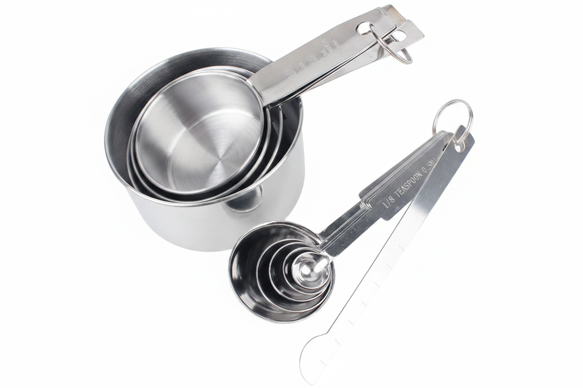 Stainless steel measuring cups and spoons set on white background