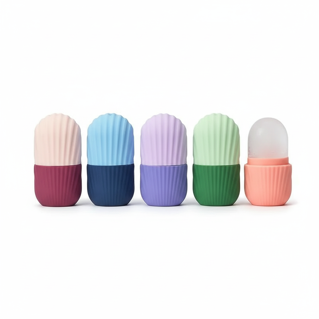 Studio photo of four silicone face ice moulds in pink, blue, purple and green on white