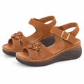 Tan wedge sandals on a white background